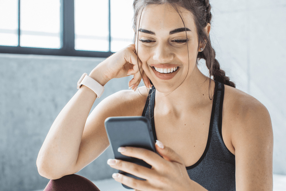 Female Gym Instructor on Smartphone