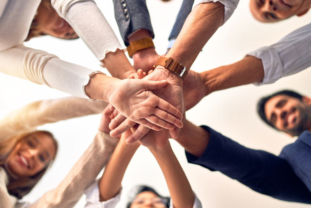 Group of workers with hands in circle